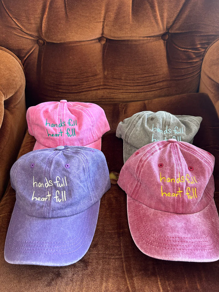 Collection of "Hands Full, Heart Full" adults caps in vibrant washed shades of cherry red, lilac, and lavender, all featuring front and back embroidery – perfect gifts for mums who juggle it all with love.