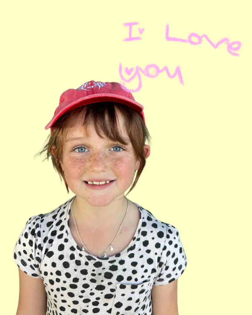 Child wearing Grow You, Grow Me cap in Washed Watermelon red, featuring hand-drawn flower artwork, perfect for kids aged 0–8 years.