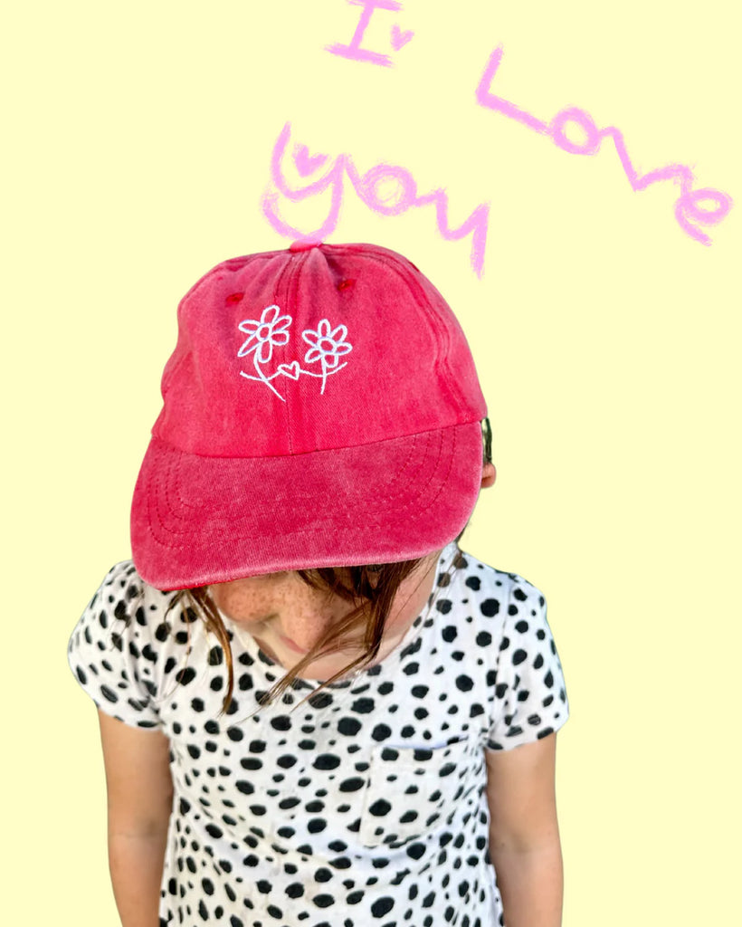 Child wearing Grow You, Grow Me cap in Washed Watermelon red, featuring hand-drawn flower artwork, perfect for kids aged 0–8 years.