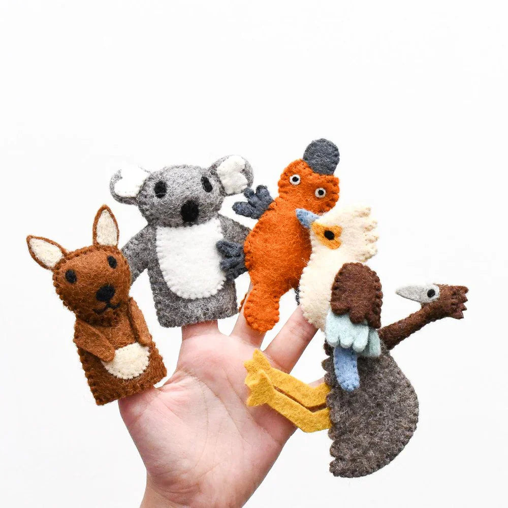 Hand holding felt Australian animal finger puppets including kangaroo, koala, emu, kookaburra, and platypus, made from organic wool.
