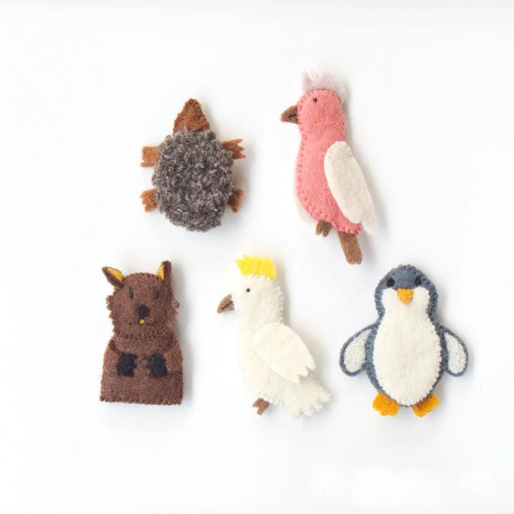 Wool felt Australian animal puppets including pink galah, black and white penguin, and brown wombat laid out for play.