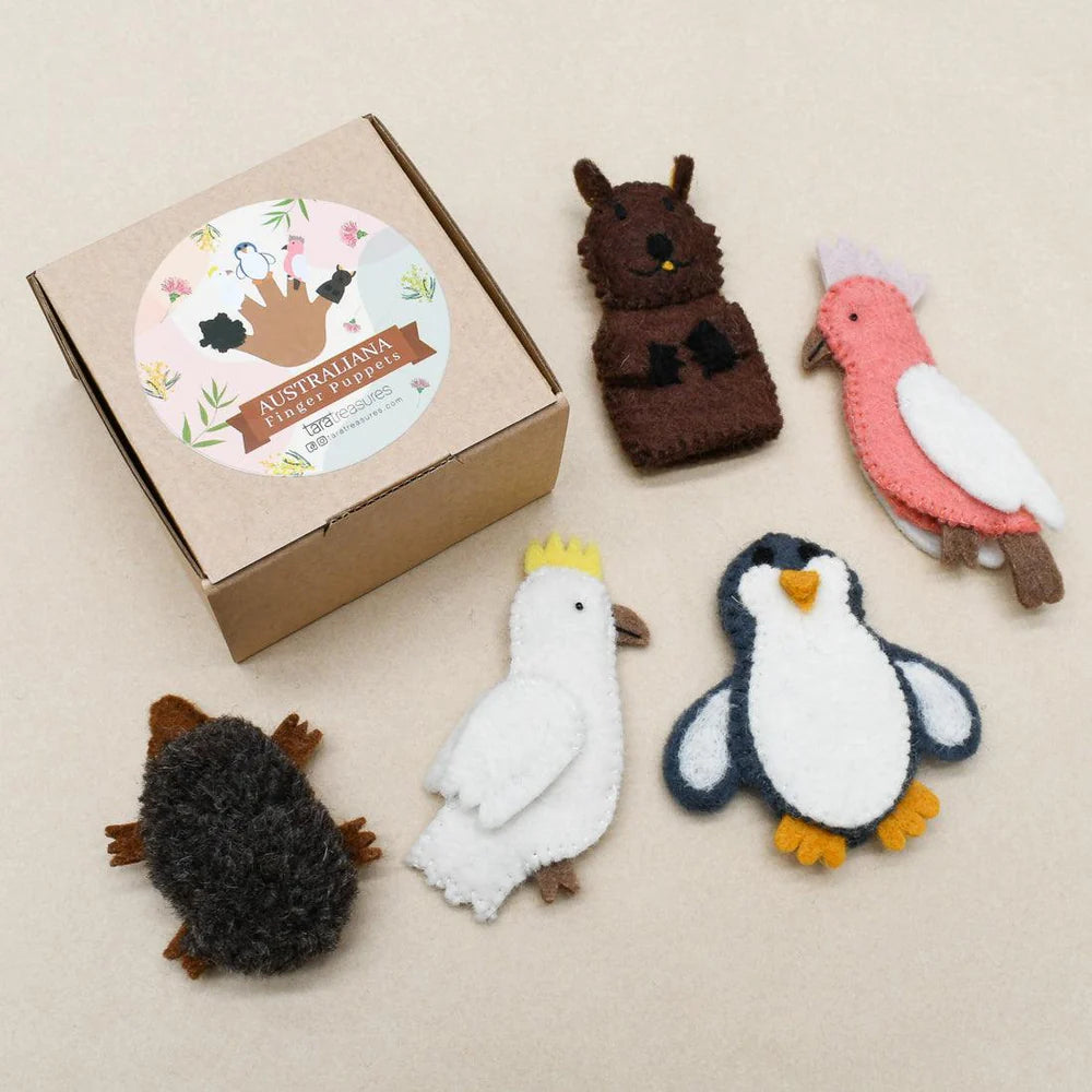 Flat lay of five felt Australian animal finger puppets beside branded Tara Treasures box—features cockatoo, wombat, and penguin.