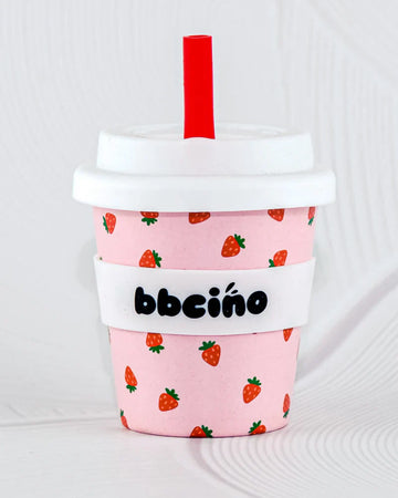 BBCino 120ml reusable cup in a pink and red strawberry design, made from sustainable bamboo. Lightweight, durable, and perfect for babycinos, espressos, or small drinks.