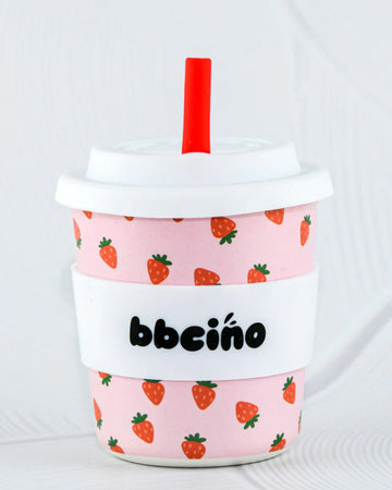 BBCino BambinoCino 240ml reusable cup in pink featuring strawberries, made from sustainable bamboo. Lightweight, durable, with a rounded base to prevent tipping, perfect for hot or cold drinks.