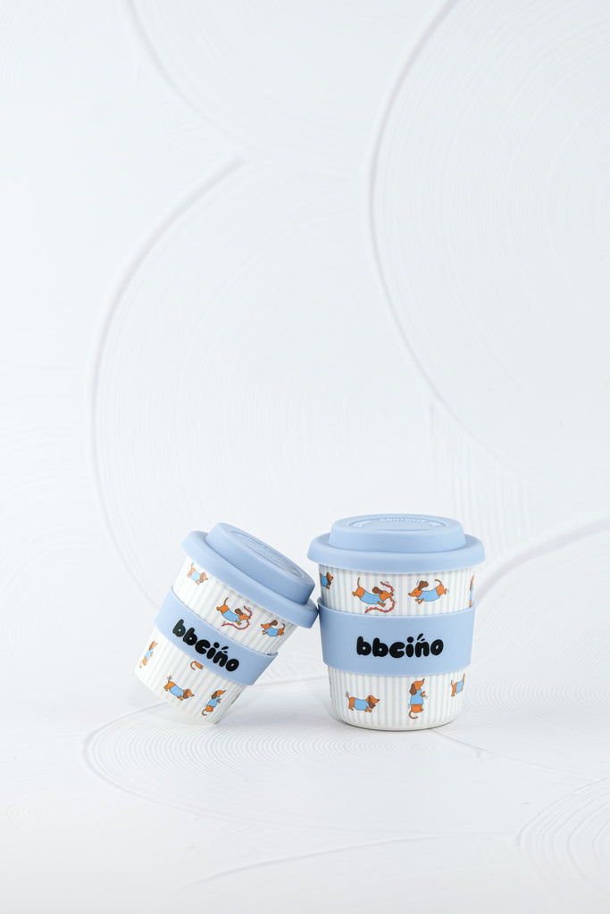Pair of BBCino reusable bamboo cups 120ml in Dash in Blue dachshund dog print with blue silicone lids, eco-friendly alternative to disposable cups.