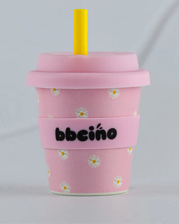 BBCino 120ml reusable cup in baby pink with a daisy design, made from sustainable bamboo. Lightweight, durable, and perfect for babycinos, espressos, or small drinks.