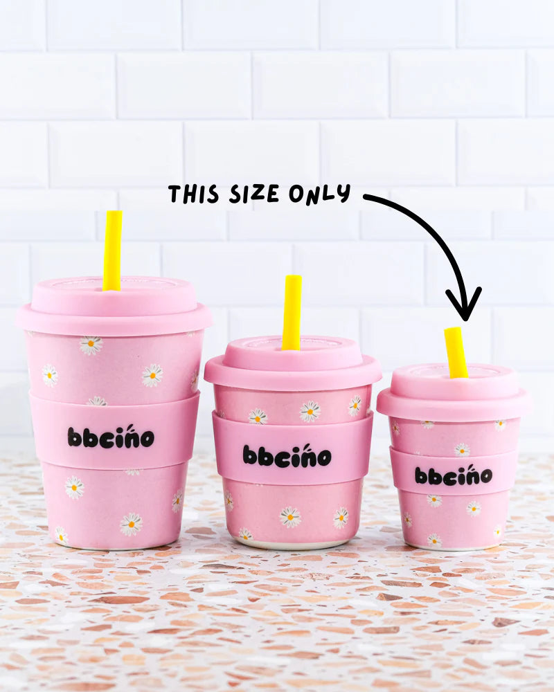 Set of reusable bamboo kids’ cups with pink and yellow daisy design, perfect for babycinos, milkshakes or juice.