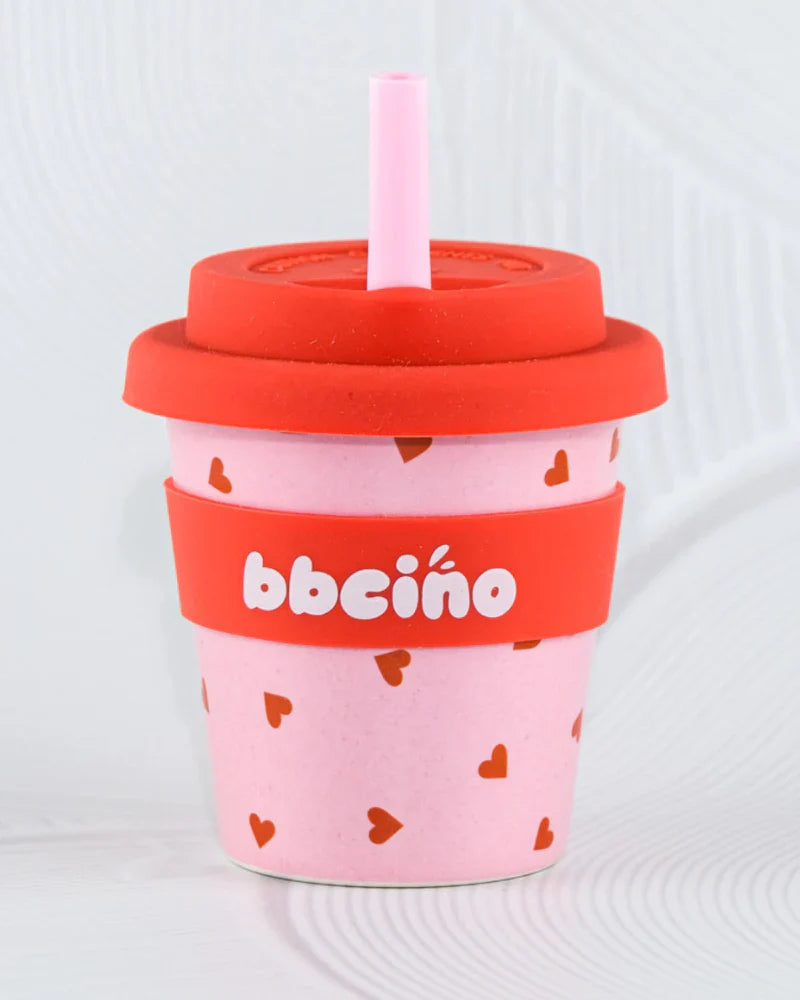 BBCino 120ml reusable cup with a pink and red heart design, made from sustainable bamboo. Lightweight, durable, and perfect for babycinos, espressos, or small drinks.