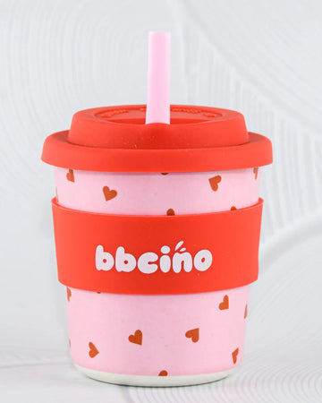 BBCino BambinoCino 240ml reusable cup with a pink and red heart design, made from sustainable bamboo. Lightweight, durable, with a rounded base to prevent tipping, perfect for hot or cold drinks.