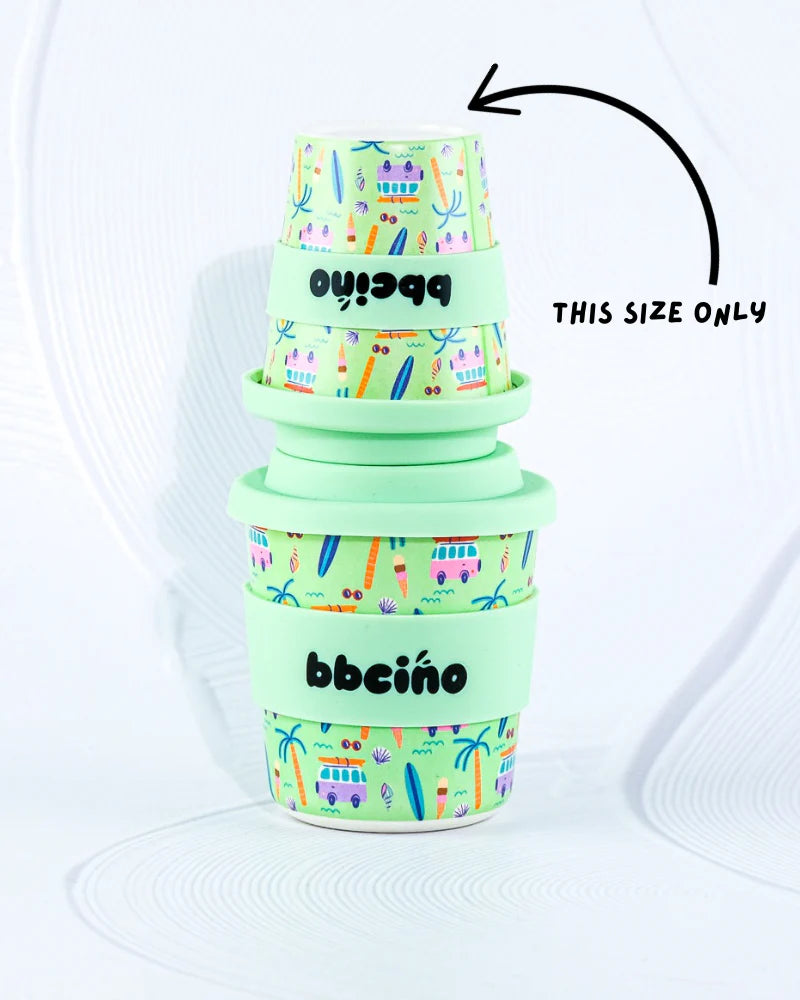 Bbcino 120ml reusable cup  stacked on top of 240ml cup for size comparison. Cups have beach themed design on a mint green background, with a mint green lid and navy straw.