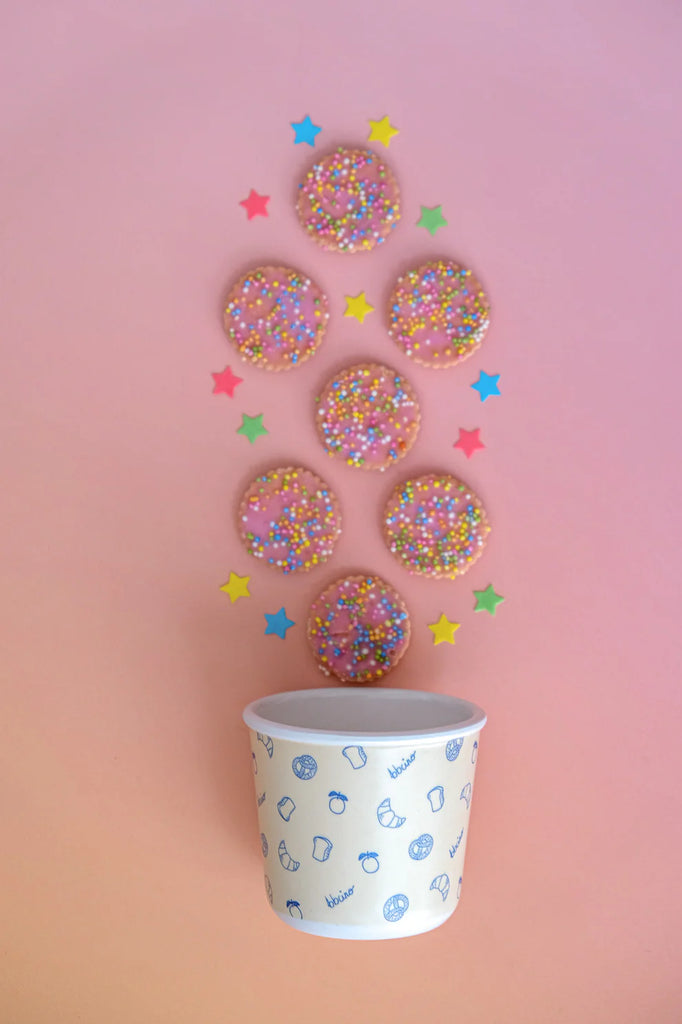 BBCino Brunch-Kins bamboo snack pot with navy lid, styled with sprinkle biscuits on pink background, sustainable reusable container.