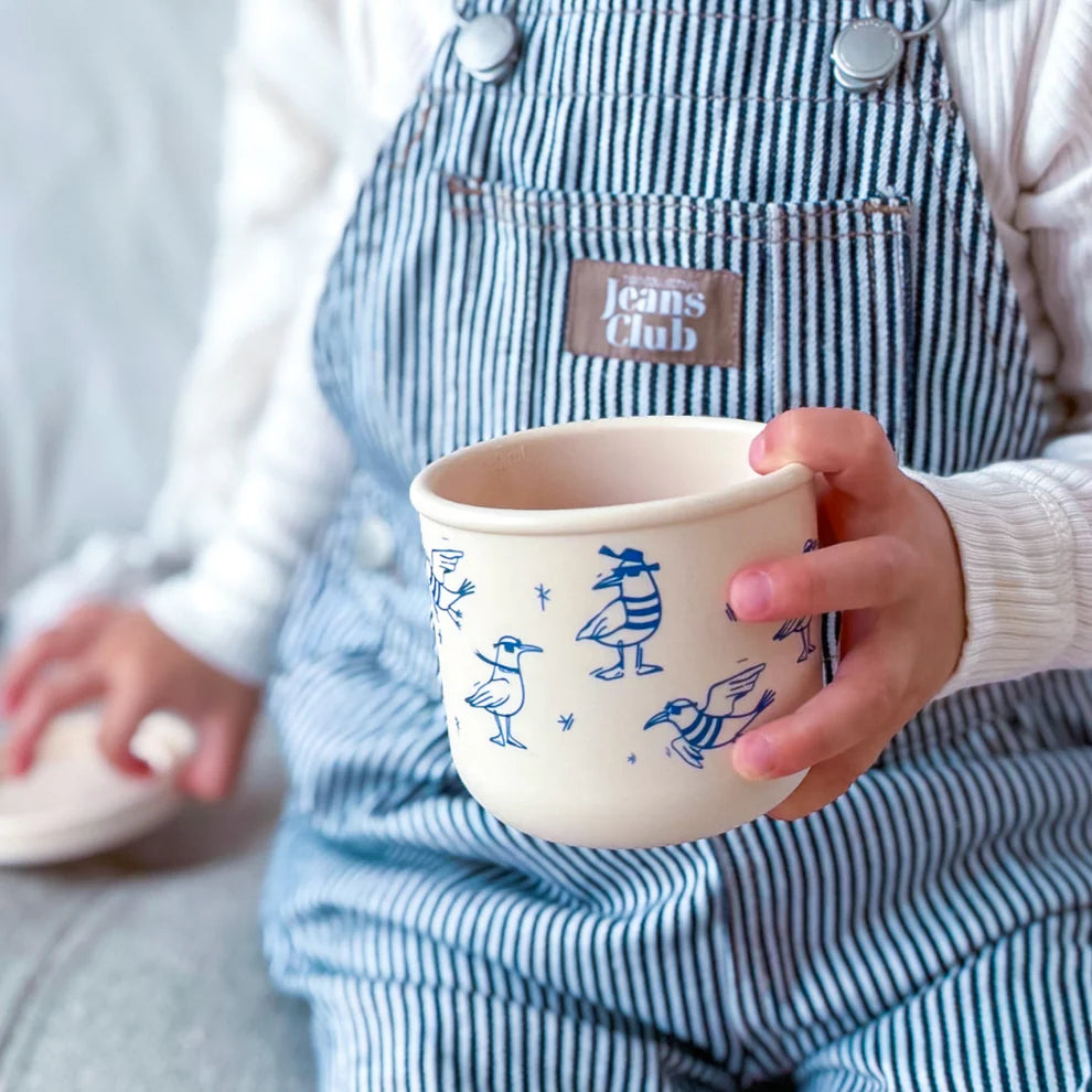 Child holding BBCino reusable silicone snack pot in Chippie Crew seagull design, 250ml unbreakable and leak-resistant container for kids’ snacks.