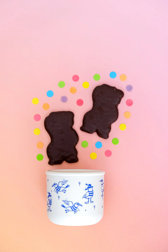 BBCino Chippie Crew silicone snack pot with blue seagull print, styled with chocolate biscuits and colourful confetti, eco-friendly reusable container.