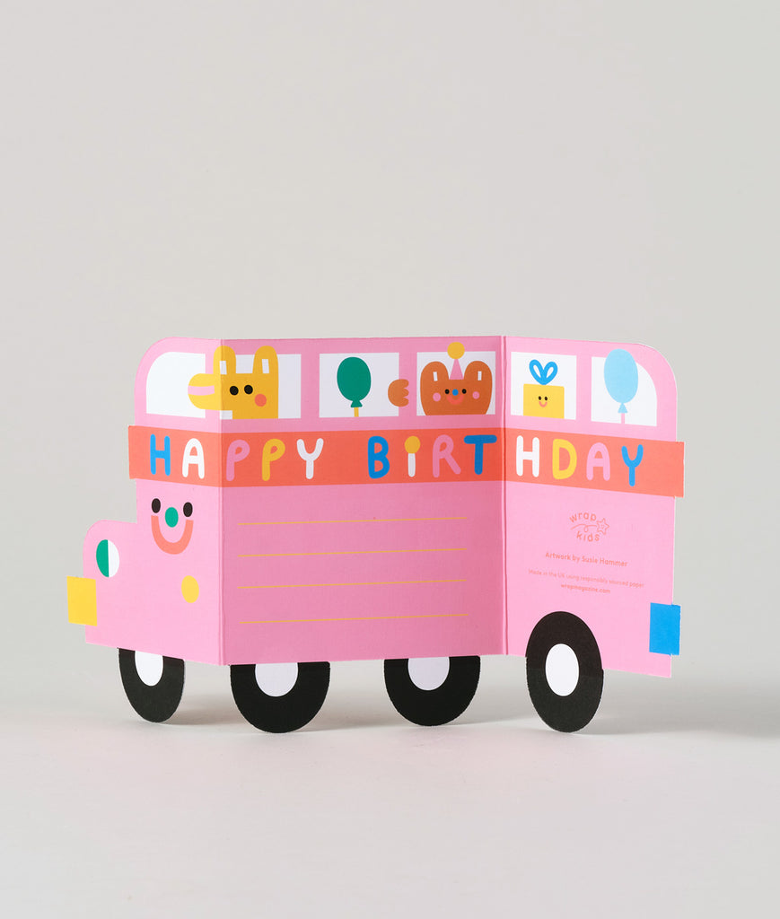 Side view of fold-out birthday bus card partially opened, revealing vibrant details and smiling animals in each window.