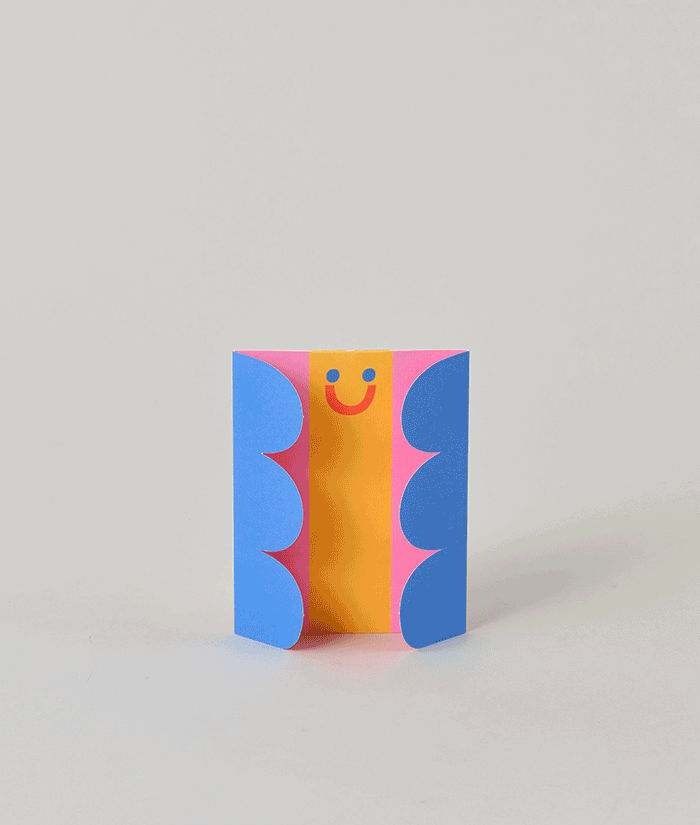 Partially opened butterfly fold-out card with cheerful face and bright colours, showing the unfolding wings design.