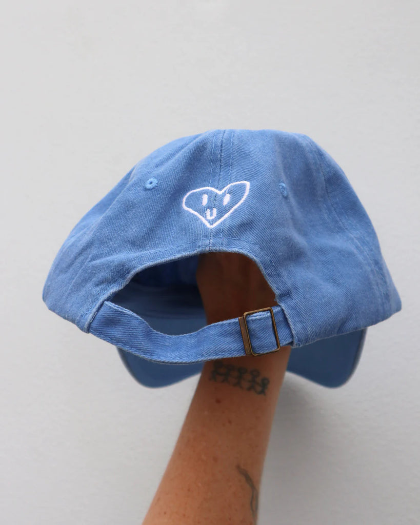 Back view of the cobalt blue "Handful" cap showing heart embroidery detail and adjustable strap for a comfy, custom fit.