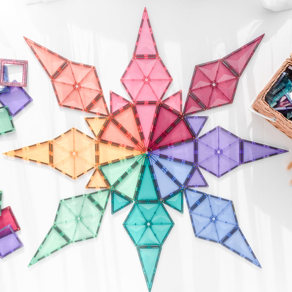 A large pastel geometric star design built with triangles and hexagons on a white surface, showcasing the variety of shapes and colours.
