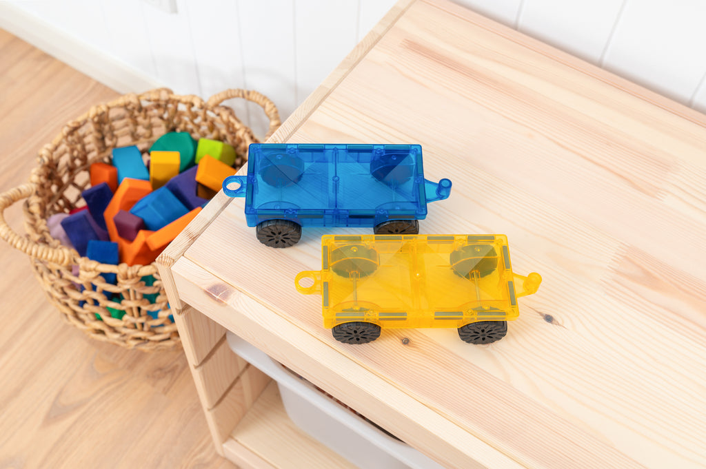 Connetix Rainbow Car Pack bases and magnetic tile cars arranged on a wooden tray, showcasing play setup.