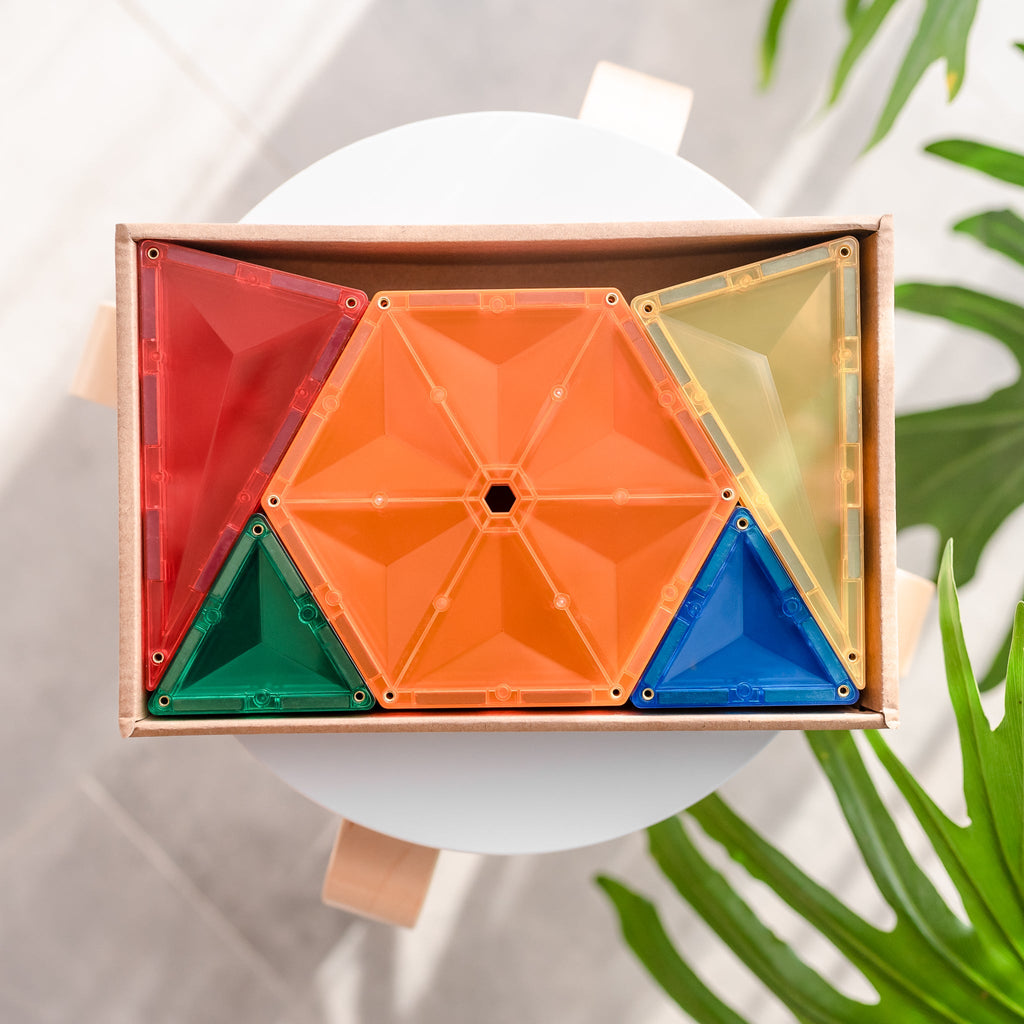 Flat lay of a circular shape made from hexagons and triangles neatly arranged inside a shallow wooden tray.