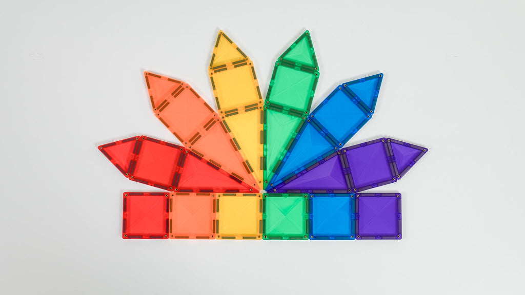 Rainbow fan-like pattern built with Connetix tiles in red, orange, yellow, green, blue, and purple, arranged neatly on a white background.