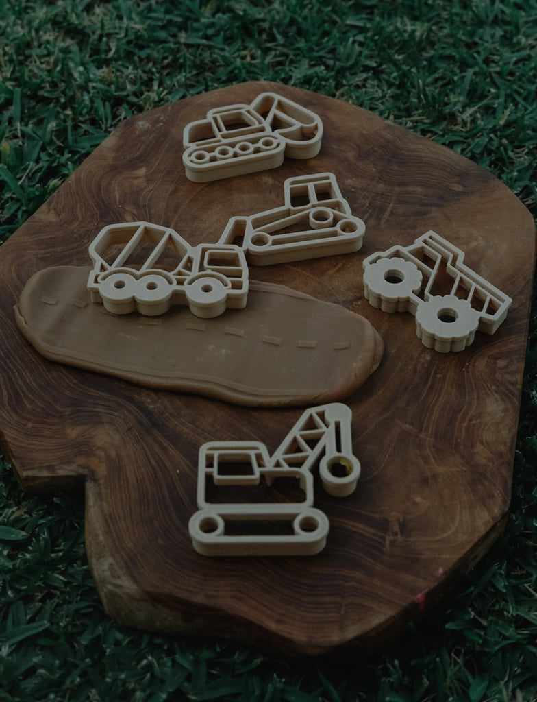 Set of  Kinfolk Pantry construction-themed cutters on a wooden board with grass background