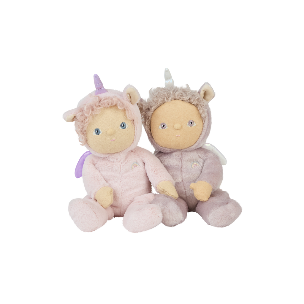 Pair of Dinky Dinkum dolls – Una Unicorn and Uma Unicorn – dressed in unicorn onesies, sitting together against a white backdrop.