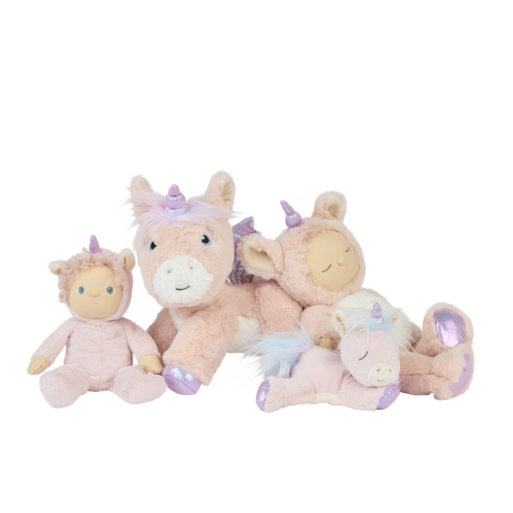 Una Unicorn plush doll surrounded by other unicorn toys – displayed with matching Olli Ella unicorn plushes on pink starry background.