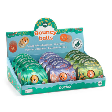 Display box of Djeco natural rubber bouncing balls, each in a colourful illustrated gift box with animal designs including lions, monkeys, and tigers.