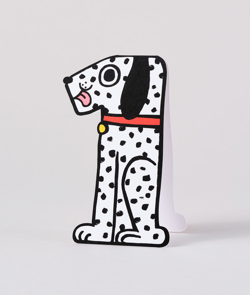 Die-cut 1st birthday card shaped like a spotted dog with a red collar and large number 1, standing upright on a white background.