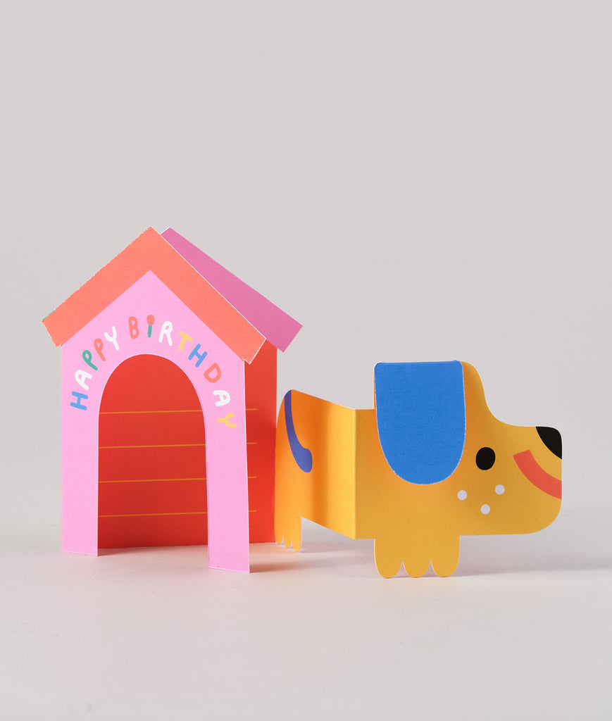 Back view of the fold-out card showing the dog’s body and pink doghouse, folded slightly for a three-dimensional look.