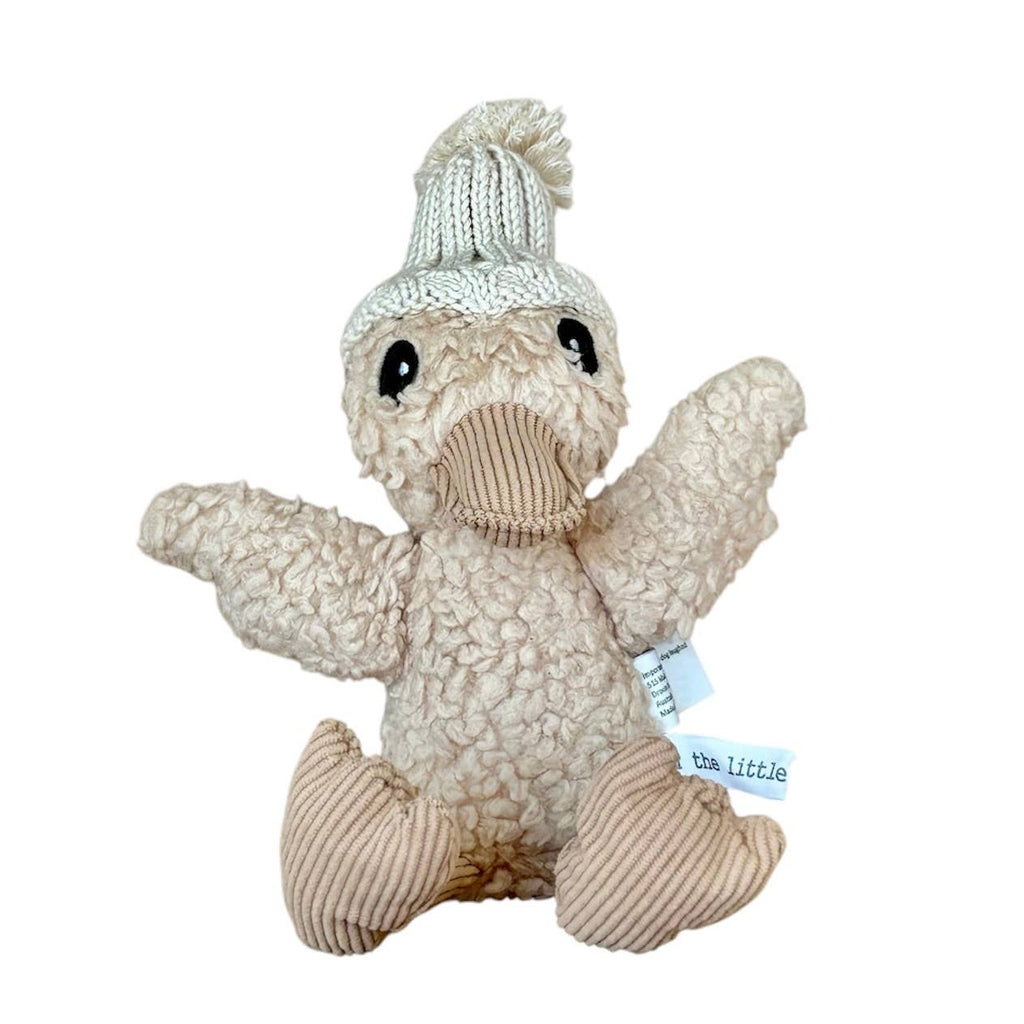 Edmond Duck plush toy sitting upright against a plain white background, showing detailed stitching, soft textured fabric, and cosy knitted beanie.