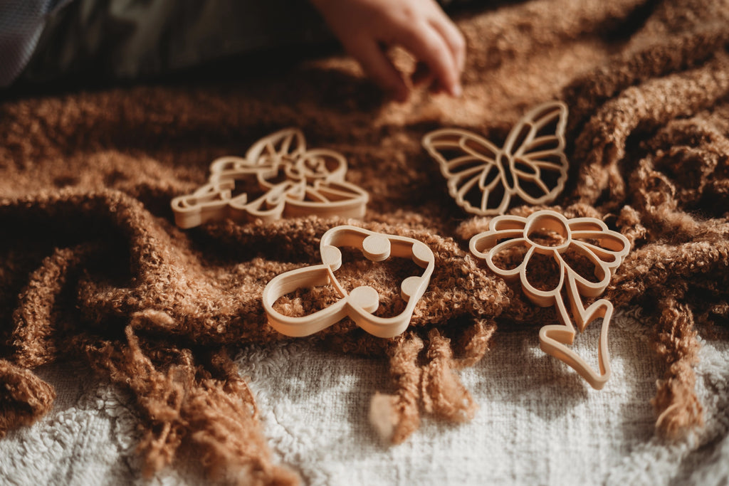 Close-up of eco-friendly fairy and butterfly dough cutters made from recycled sawdust and PLA plastic.