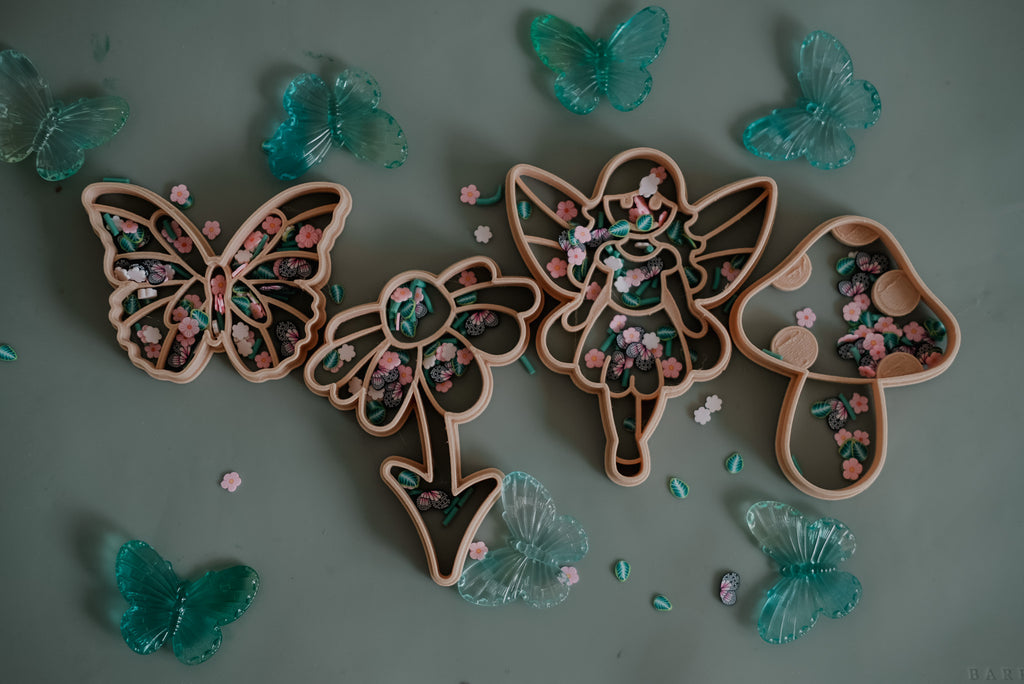 Fairy-themed cutter set styled with blue butterflies and sparkles for imaginative sensory play.