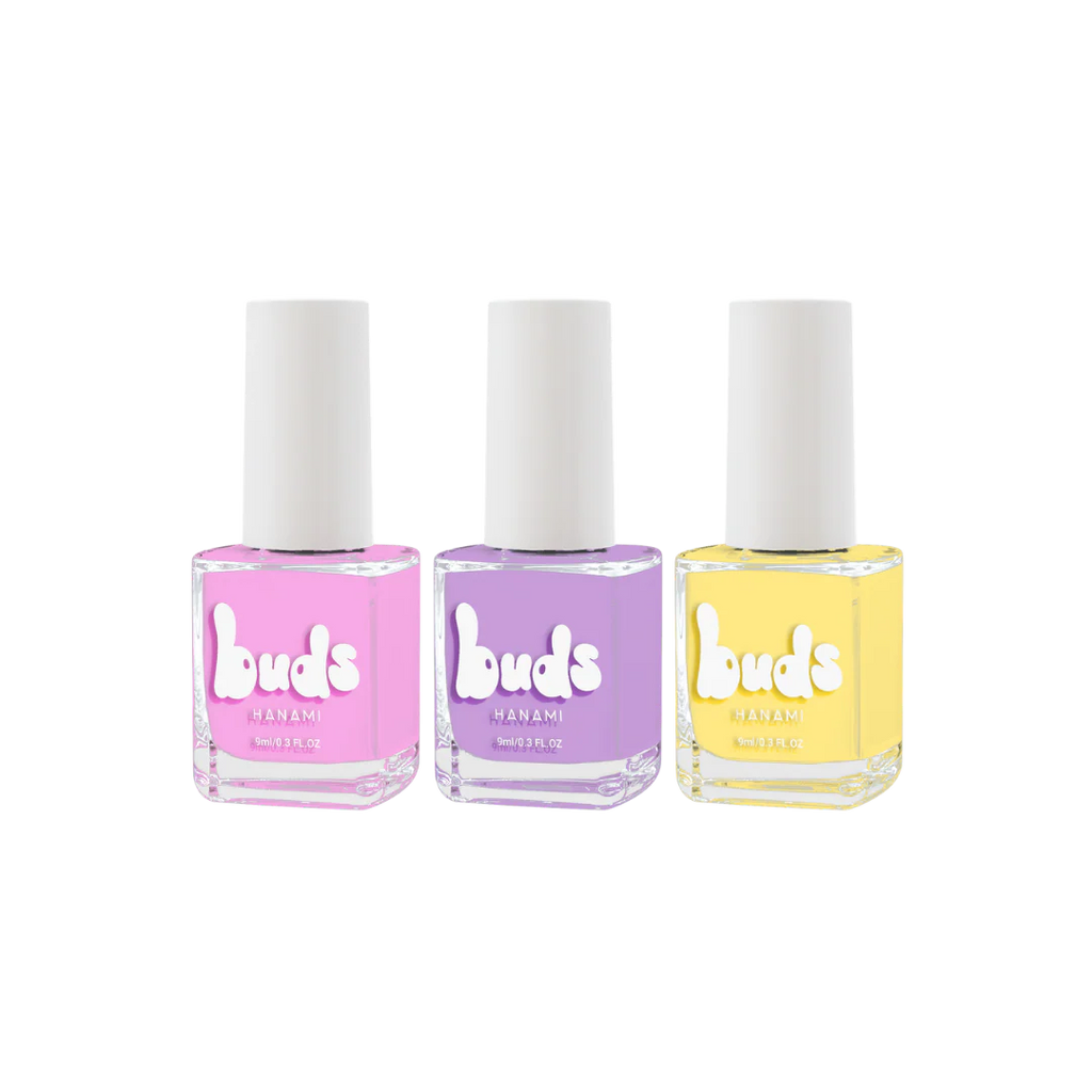 Three Buds Hanami kids’ nail polish bottles in a row: pink, purple, and light yellow, displayed against a clean white background.