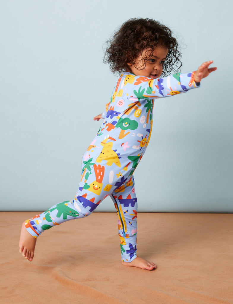 Side view of toddler walking in Dino Days Halcyon Nights romper, highlighting playful movement, soft fabric, and fun dinosaur design.
