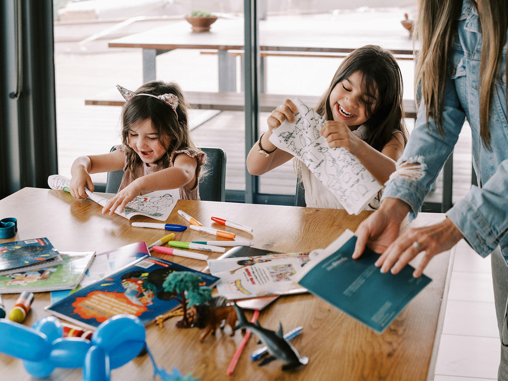 Kids enjoying HeyDoodle Aussie Animals mat with craft supplies spread out on the table.