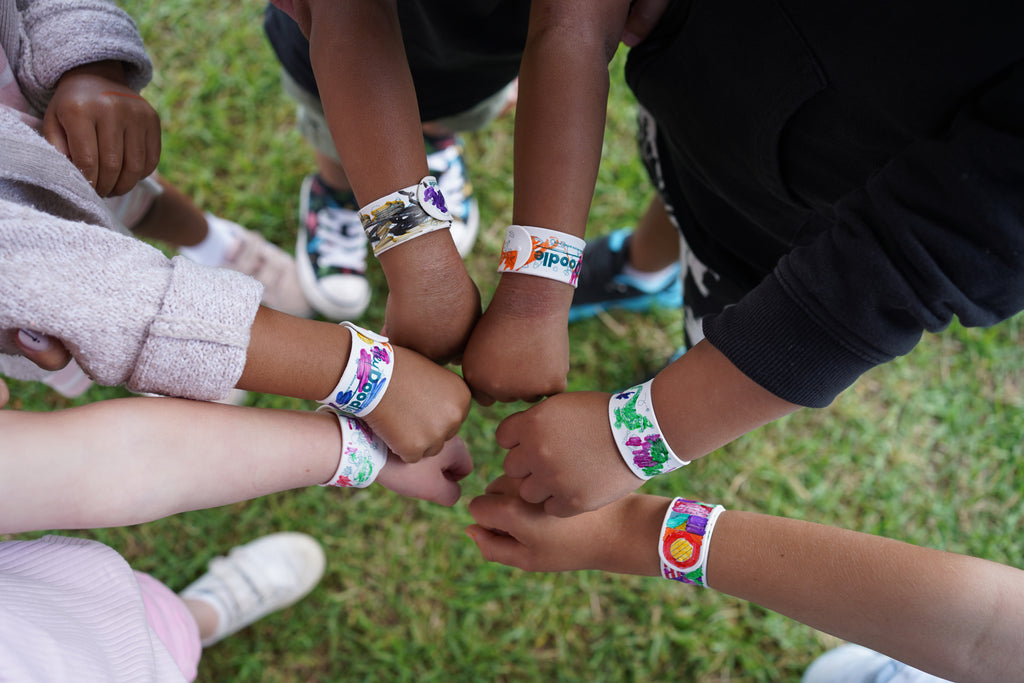 Group of children wearing coloured HeyDoodle Sketchbands at a party.