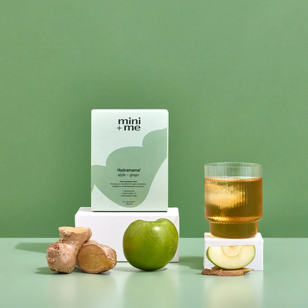 Hydramama box and sachet displayed with a glass of mixed drink, green apple, ginger slices, and lemon, representing the flavour profile and hydration benefits.