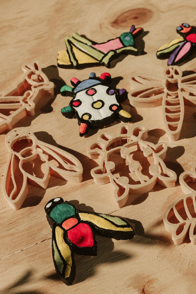 Bug-shaped eco dough cutters during outdoor-inspired craft time.
