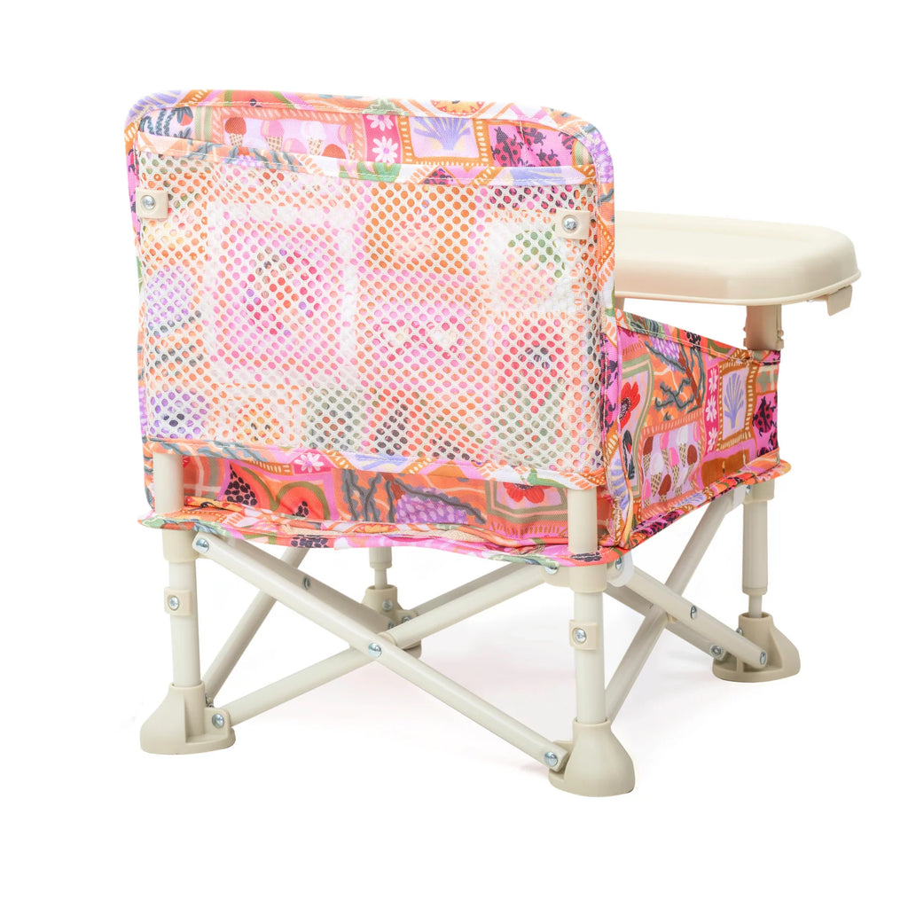 Back view of the Izimini Baby Chair showing its foldable frame, mesh backrest, and colorful Amy patchwork fabric.