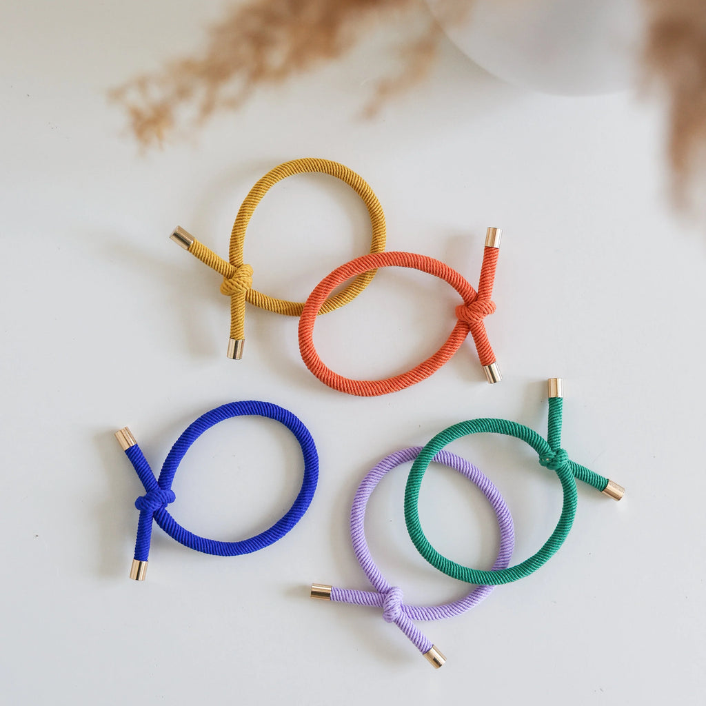 Set of colorful hair ties on a light background