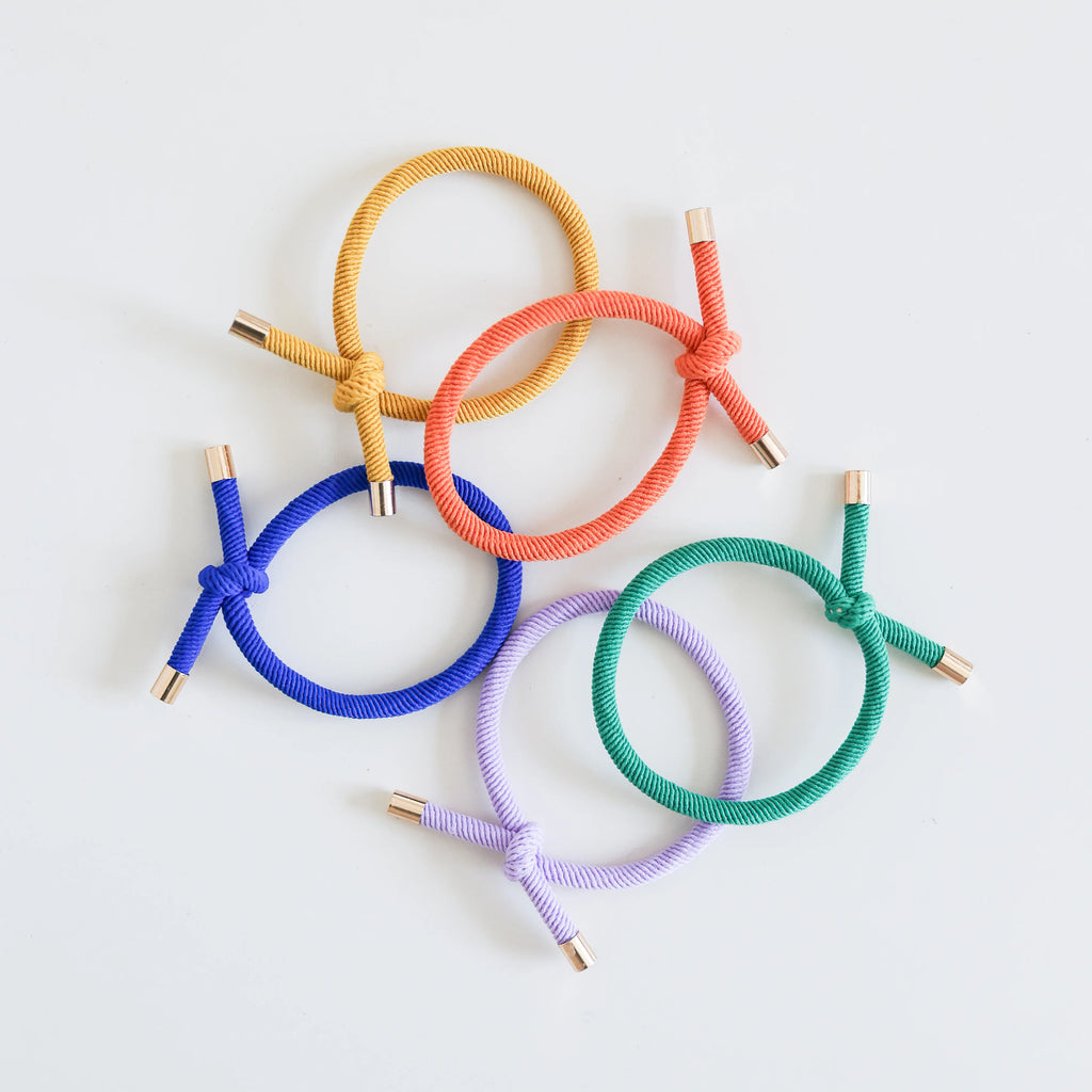 Set of colorful hair ties on a light gray background