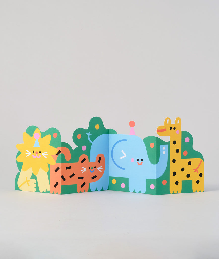 Fold-out jungle birthday card fully opened, showing a colourful lineup of animals including a lion, tiger, elephant, and giraffe in a playful scene.