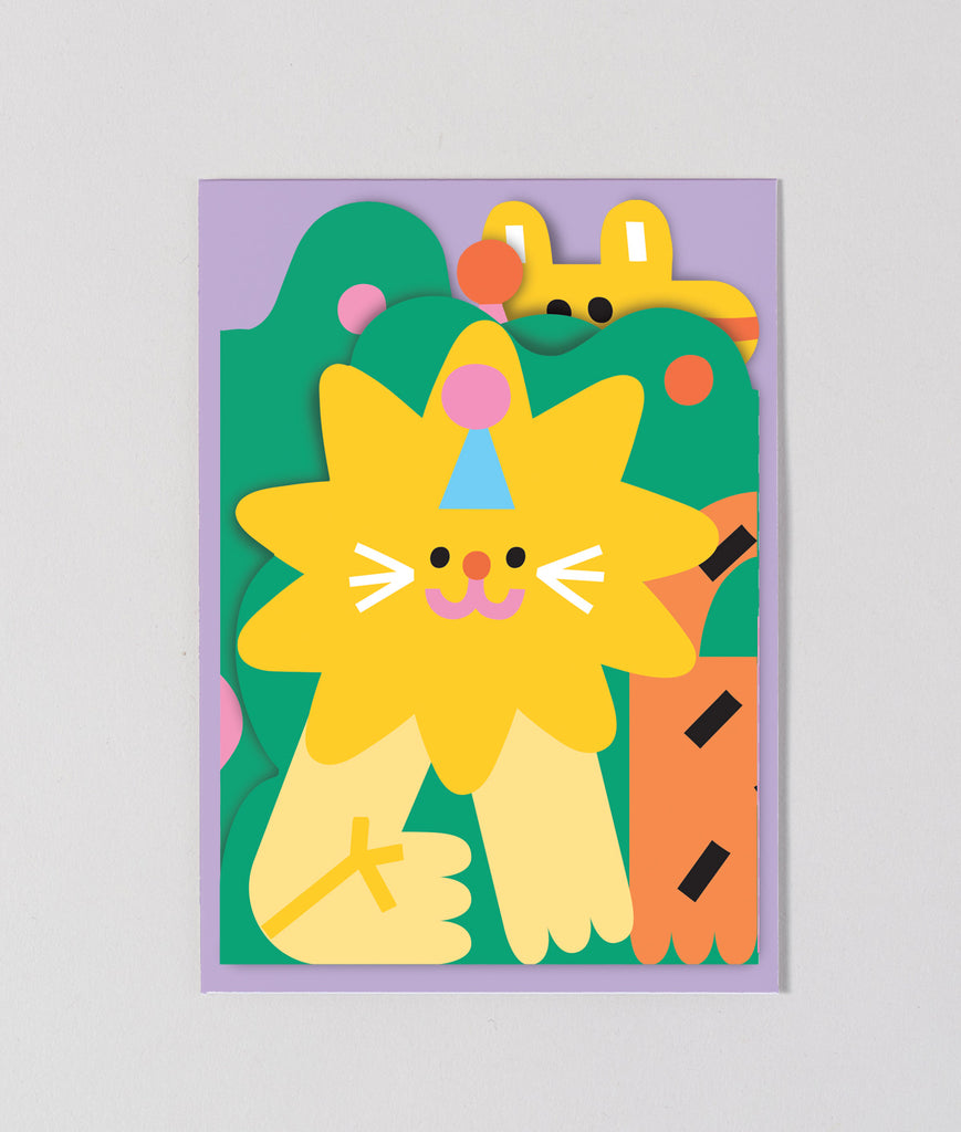 Folded jungle birthday card placed on top of its matching yellow envelope, ready for gifting, showing the front design with lion, tiger, and elephant.