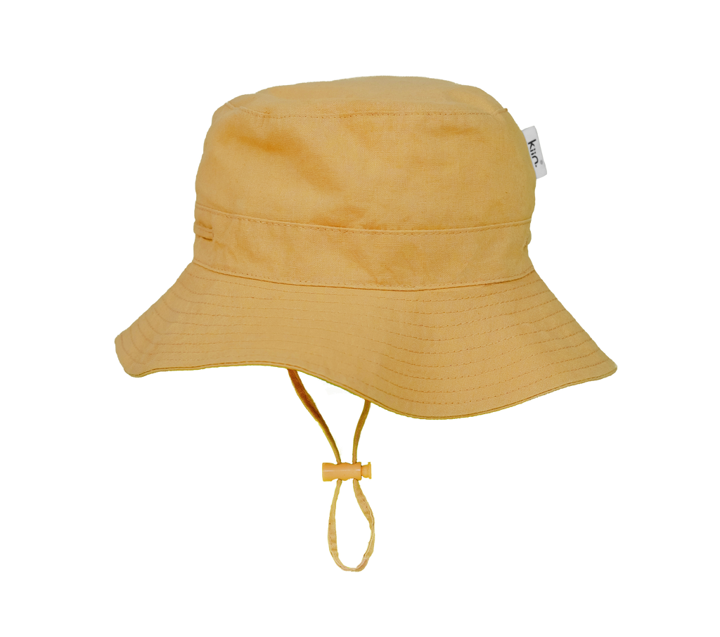 Golden Tan Kiin Baby sun hat with a wide brim and breakaway safety clip. Made from 100% cotton with adjustable toggles for a secure fit, providing UPF 50+ excellent sun protection. Perfect for babies and toddlers.