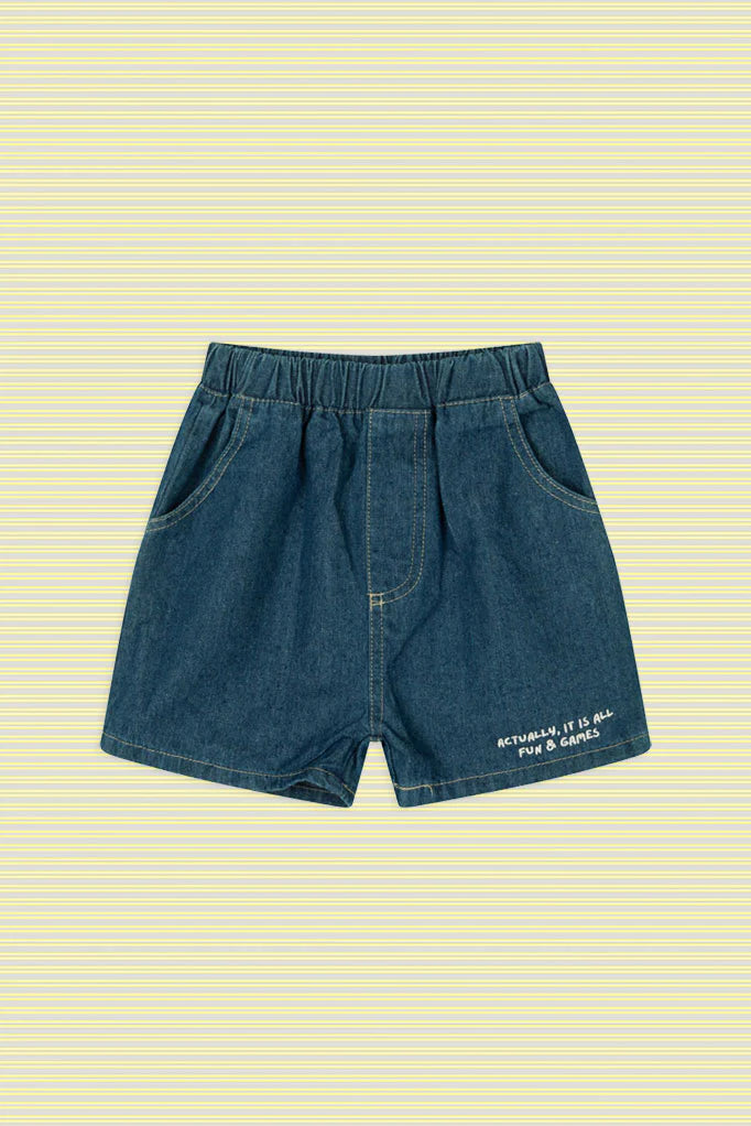 Flat lay of Lenn Label Fun & Games lightweight denim short featuring embroidered text on a yellow striped background.