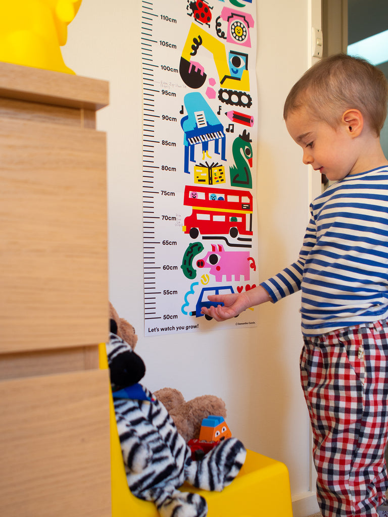 Vibrant height chart featuring playful illustrations of dogs, elephants, planes, and dinosaurs, designed by Melbourne illustrator Samantha Curcio. Made with durable, high-quality material, perfect for tracking growth in bedrooms or playrooms.