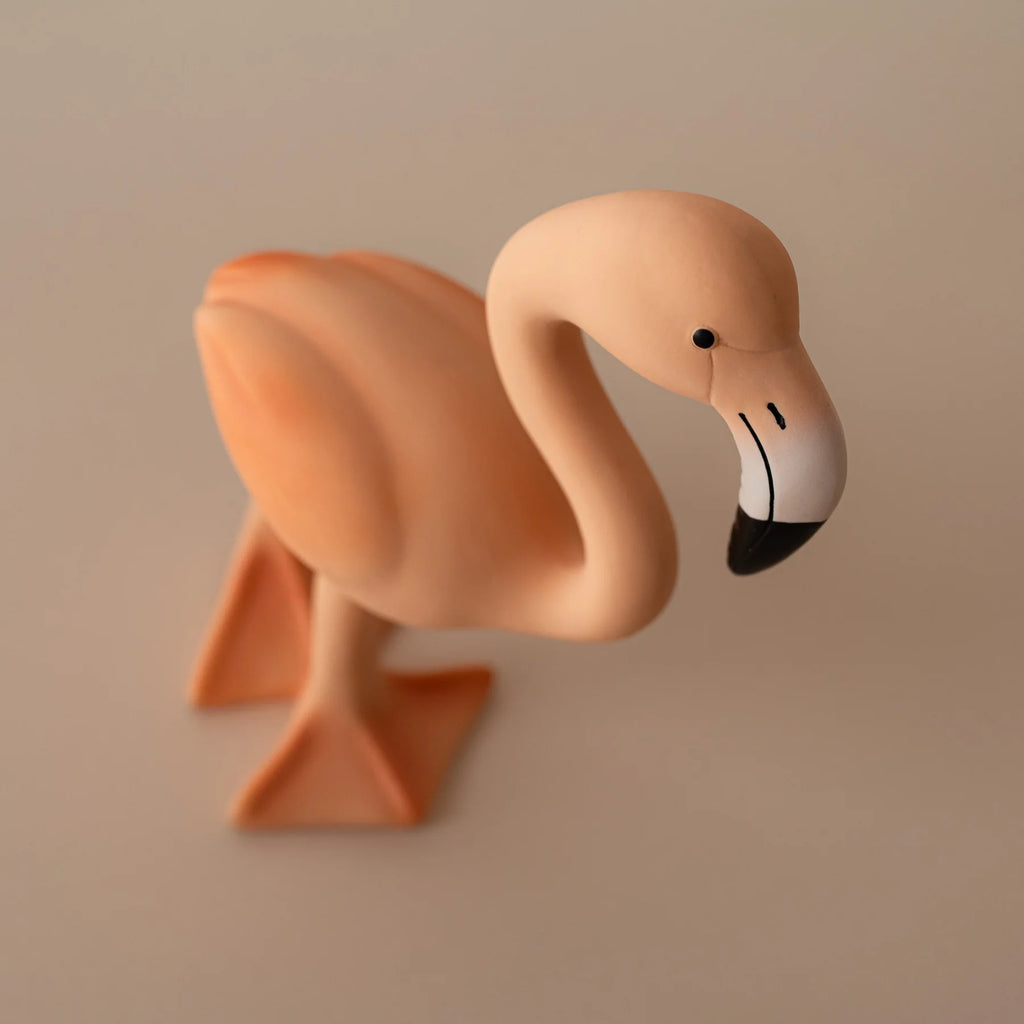 Pink flamingo figurine on a beige background