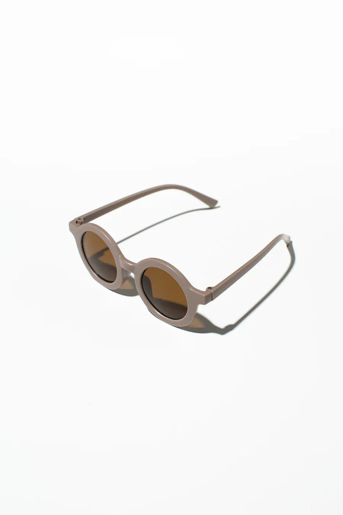 A pair of kids' sunglasses with a biscuit color frame, displayed on a white background.