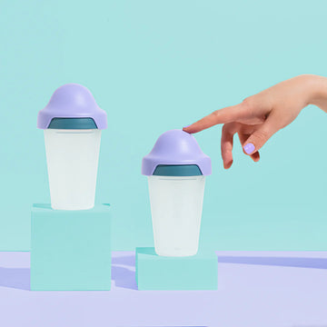 Little Stackers 240ml Baby Bottle Twin Pack in green and purple, suitable for 3–6 months. Features a breast-like teat, stackable design, and easy transition to a sippy cup. BPA-free, dishwasher and microwave safe.